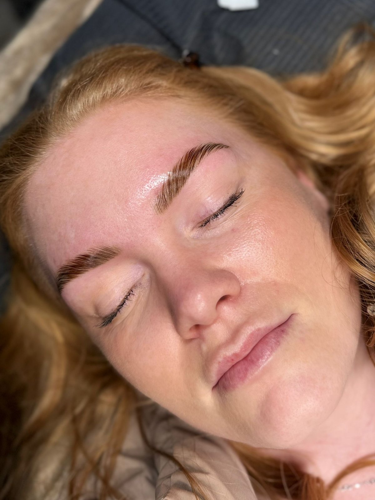 Brow lamination on red-haired client — fluffy laminated finish